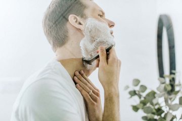 Man using a shaving cream that numbs the skin.